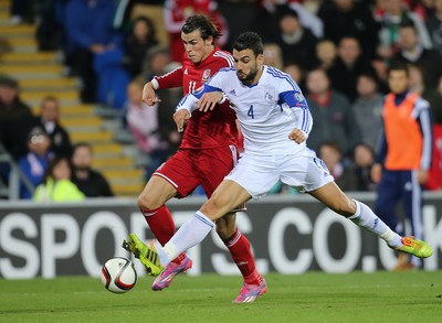 131014 - Wales v Cyprus, UEFA European Championship Qualifier - Wales' Gareth Bale takes on Giorgos Merkis of Cyprus