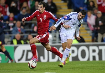 131014 - Wales v Cyprus, UEFA European Championship Qualifier - Wales' Gareth Bale takes on Giorgos Merkis of Cyprus