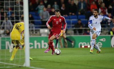 131014 - Wales v Cyprus, UEFA European Championship Qualifier - Wales' Gareth Bale narrowly misses goal after putting the ball past Tasos Kissas of Cyprus