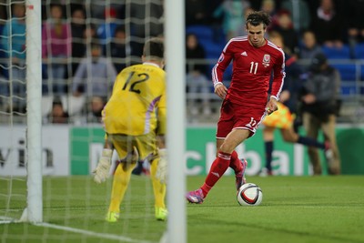 131014 - Wales v Cyprus, UEFA European Championship Qualifier - Wales' Gareth Bale narrowly misses goal after putting the ball past Tasos Kissas of Cyprus