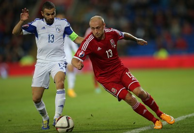 131014 - Wales v Cyprus, UEFA European Championship Qualifier - Wales' David Cotterrill takes on Constantinos Makridis of Cyprus
