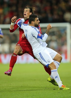 131014 - Wales v Cyprus, UEFA European Championship Qualifier - Wales' Gareth Bale is caught high by Giorgos Merkis of Cyprus