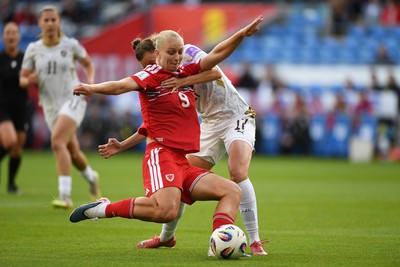 090626 - Wales Women v Czech Republic Women - 2027 FIFA Women's World Cup Qualifying - Elise Hughes of Wales is pulled back by Barbora Polcarova of Czech Republic as she takes a shot
