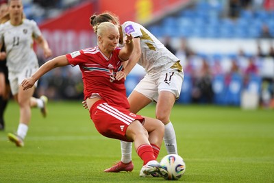 090626 - Wales Women v Czech Republic Women - 2027 FIFA Women's World Cup Qualifying - Elise Hughes of Wales is pulled back by Barbora Polcarova of Czech Republic as she takes a shot