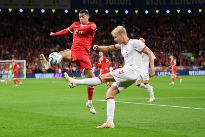 041026 - Wales v Denmark - UEFA Nations League - Brennan Johnson of Wales is challenged by Oliver Provstgaard of Denmark