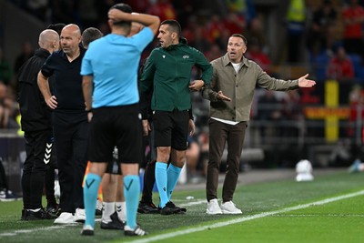 041026 - Wales v Denmark - UEFA Nations League - Craig Bellamy, Wales Manager debates  with Denmark assistant coaches 