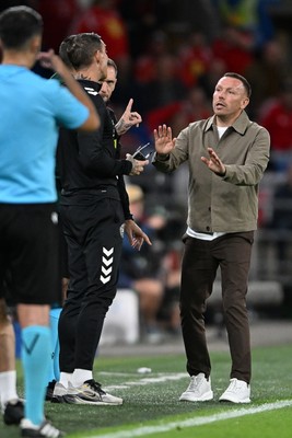 041026 - Wales v Denmark - UEFA Nations League - Craig Bellamy, Wales Manager debates  with Denmark assistant coaches 