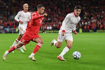 041026 - Wales v Denmark - UEFA Nations League - Brennan Johnson of Wales is challenged by Joakim Maehle of Denmark