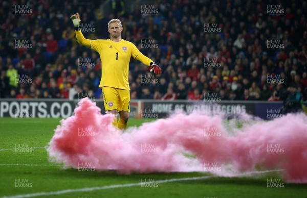 161118 - Wales v Denmark - UEFA Nations League B - Kasper Schmeichel of Denmark looks on as a flare is thrown onto the pitch
