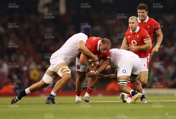 050823 - Wales v England - Vodafone Summer Series - Corey Domachowski of Wales is tackled by George Martin and Lewis Ludlam of England 