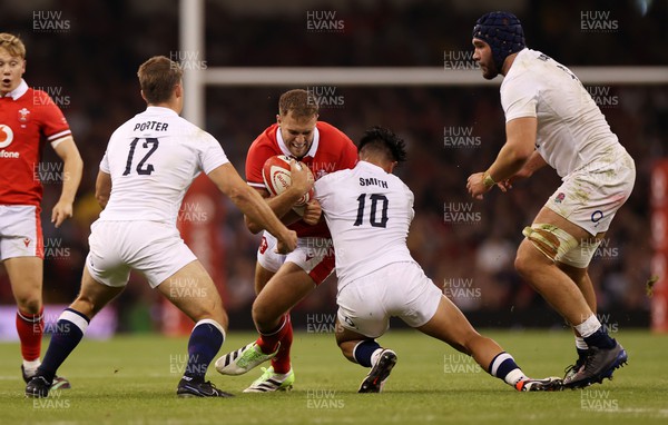 050823 - Wales v England - Vodafone Summer Series - Max Llewellyn of Wales is tackled by Marcus Smith of England 
