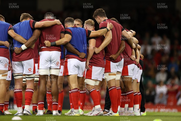 050823 - Wales v England - Vodafone Summer Series - Wales huddle in warm up jerseys