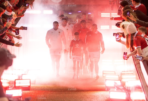 050823 - Wales v England - Vodafone Summer Series - Captains Ellis Genge and Jac Morgan of Wales lead the team out with the mascot