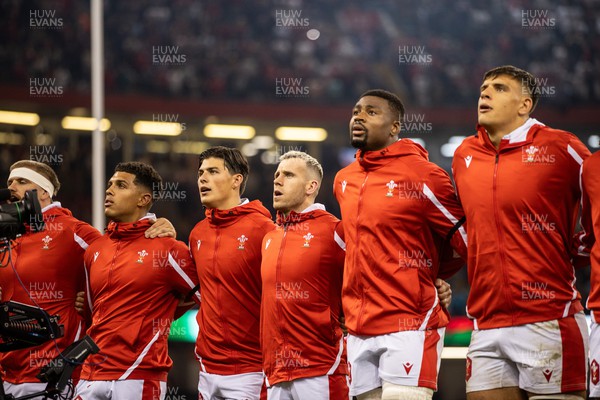 050823 - Wales v England - Vodafone Summer Series - Rio Dyer, Louis Rees-Zammit, Gareth Davies, Christ Tshiunza and Dafydd Jenkins of Wales sing the anthem