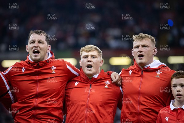 050823 - Wales v England - Vodafone Summer Series - Ryan Elias, Sam Costelow and Jac Morgan of Wales sing the anthem