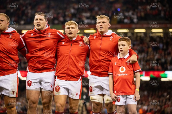 050823 - Wales v England - Vodafone Summer Series - Ryan Elias, Sam Costelow and Jac Morgan of Wales sing the anthem