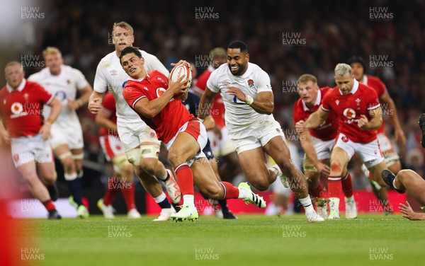 050823 - Wales v England, Vodafone Summer Series - Louis Rees-Zammit of Wales is tackled as he breaks for the line