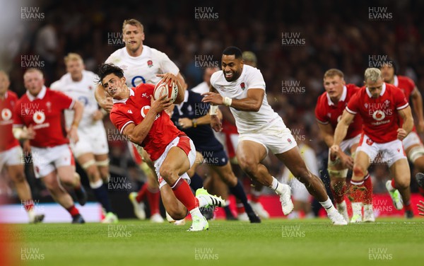 050823 - Wales v England, Vodafone Summer Series - Louis Rees-Zammit of Wales is tackled as he breaks for the line