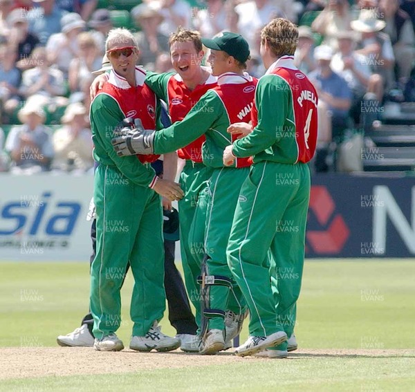 140603 - Wales v England - Wales' Robert Croft (2nd L) is congratulated after bowling out Marcus Trescothick