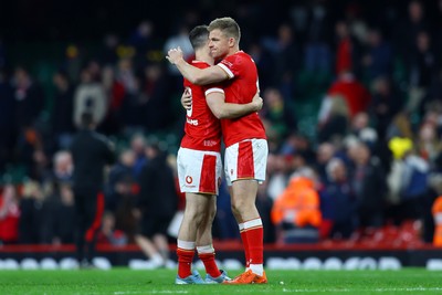 150325 - Wales v England - Guinness Six Nations - Tomos Williams and Gareth Anscombe of Wales embrace following the team's defeat