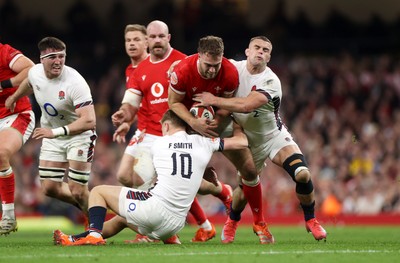 150325 - Wales v England - Guinness Six Nations Championship - Max Llewellyn of Wales is tackled by Fin Smith and Ben Earl of England 