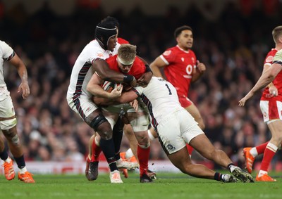 150325 - Wales v England - Guinness Six Nations Championship - Aaron Wainwright of Wales is tackled by Maro Itoje and Ellis Genge of England 