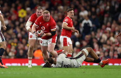 150325 - Wales v England - Guinness Six Nations Championship - Keiron Assiratti of Wales is tackled by Chandler Cunningham-South of England 