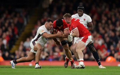 150325 - Wales v England - Guinness Six Nations Championship - Dafydd Jenkins of Wales is tackled by Ellis Genge of England 