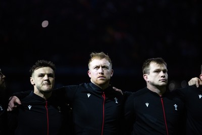 150325 - Wales v England - Guinness Six Nations Championship - Jarrod Evans, Tommy Reffell and Nick Tompkins of Wales sing the anthem