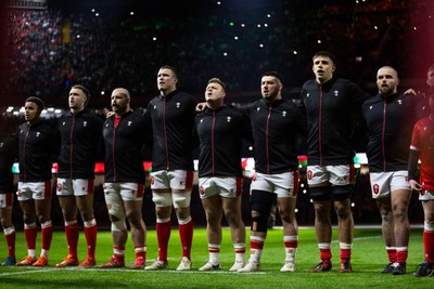 150325 - Wales v England - Guinness Six Nations Championship - Ben Thomas, Max Llewellyn, WillGriff John, Will Rowlands, Dewi Lake, Gareth Thomas, Dafydd Jenkins and Nicky Smith of Wales sing the anthem