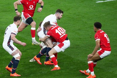 150325 - Wales v England - Guinness Six Nations - Elliot Daly of England is tackled by Gareth Anscombe of Wales