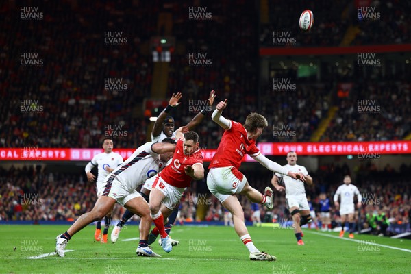 150325 - Wales v England - Guinness Six Nations - Ellis Mee of Wales kicks upfield as Tomos Williams is tackled