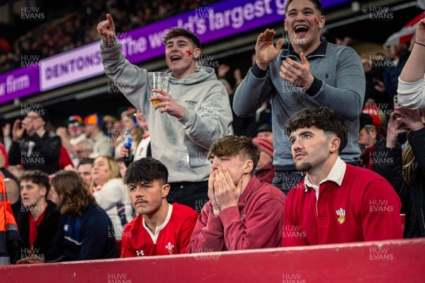 150325 - Wales v England - Guinness Six Nations - Wales Fans react while England fans celebrate during the game   