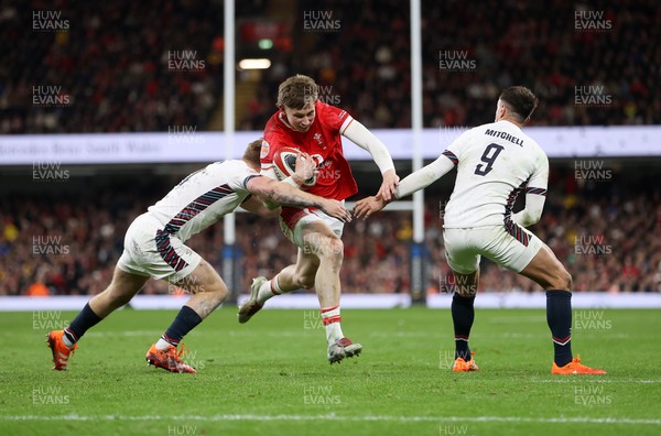 150325 - Wales v England - Guinness Six Nations Championship - Ellis Mee of Wales is tackled by Fin Smith and Alex Mitchell of England 