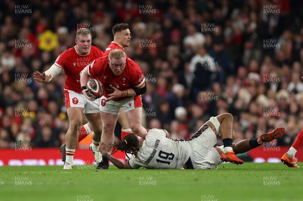 150325 - Wales v England - Guinness Six Nations Championship - Keiron Assiratti of Wales is tackled by Chandler Cunningham-South of England 