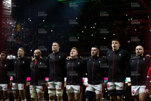 150325 - Wales v England - Guinness Six Nations Championship - Max Llewellyn, WillGriff John, Will Rowlands, Dewi Lake, Gareth Thomas, Dafydd Jenkins and Nicky Smith of Wales sing the anthem