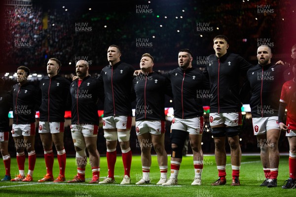 150325 - Wales v England - Guinness Six Nations Championship - Ben Thomas, Max Llewellyn, WillGriff John, Will Rowlands, Dewi Lake, Gareth Thomas, Dafydd Jenkins and Nicky Smith of Wales sing the anthem