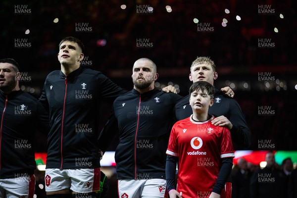 150325 - Wales v England - Guinness Six Nations Championship - Dafydd Jenkins, Nicky Smith and Jac Morgan of Wales sing the anthem