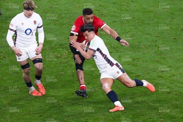 150325 - Wales v England - Guinness Six Nations - Marcus Smith of England is tackled by Taulupe Faletau of Wales