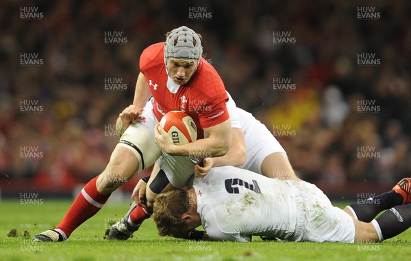 160313 - Wales v England - RBS Six Nations 2013 -Jonathan Davies of Wales is tackled by Owen Farrell and Tom Youngs of England