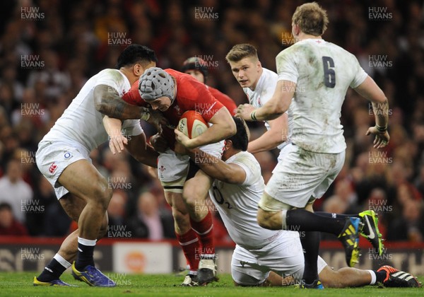 160313 - Wales v England - RBS Six Nations 2013 -Jonathan Davies of Wales is tackled by Manu Tuilagi and Mako Vunipola of England