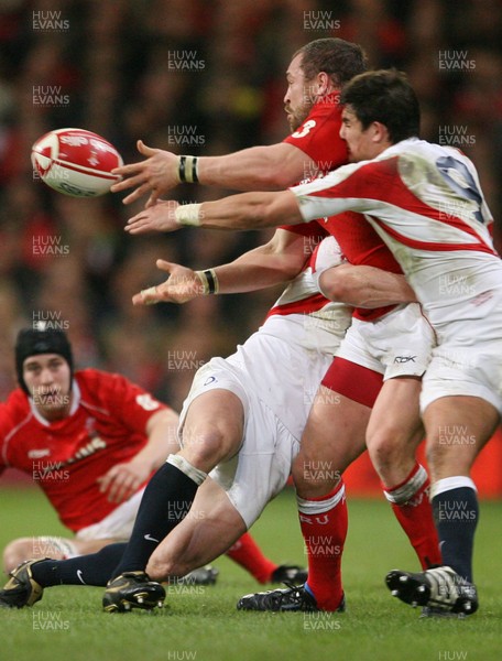 170307 - Wales v England - RBS 6 Nations -  Wales Chris Horsman passes as Harry Ellis and Tom Rees tackle 