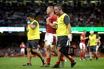 170819 - Wales v England - Under Armour Summer Series - James Davies of Wales leaves the field with Dr Geoff Davies (right)