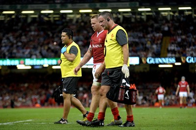 170819 - Wales v England - Under Armour Summer Series - James Davies of Wales leaves the field with Dr Geoff Davies (right)