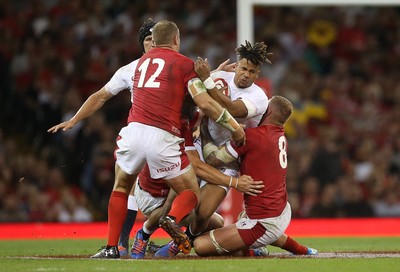 170819 - Wales v England - RWC Warm Up - Under Armour Summer Series - Anthony Watson of England is tackled by Jonathan Davies and Ross Moriarty of Wales