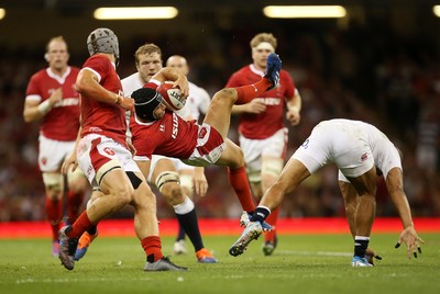 170819 - Wales v England - RWC Warm Up - Under Armour Summer Series - Leigh Halfpenny of Wales crashes to the ground after going for the high ball with Jonathan Joseph of England