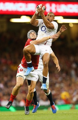 170819 - Wales v England, Under Armour Summer Series 2019 - Jonathan Joseph of England takes the ball under pressure from Jonathan Davies of Wales