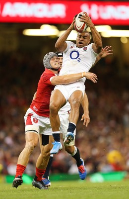 170819 - Wales v England, Under Armour Summer Series 2019 - Jonathan Joseph of England takes the ball under pressure from Jonathan Davies of Wales