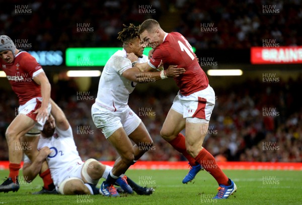 170819 - Wales v England - Under Armour Summer Series - George North of Wales is tackled by Anthony Watson of England