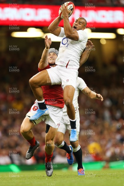 170819 - Wales v England, Under Armour Summer Series 2019 - Jonathan Joseph of England takes the ball under pressure from Jonathan Davies of Wales
